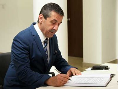 Minister Tahsin Ertuğruloğlu signed the book of condolence